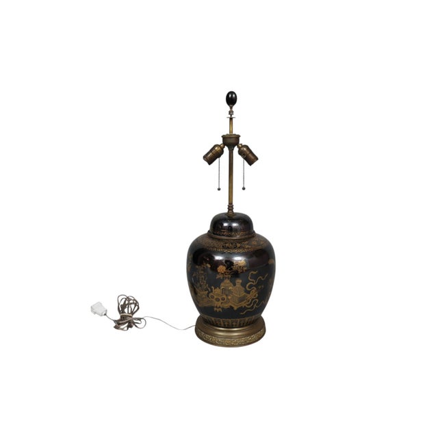A Chinoiserie ceramic table lamp. The ginger jar shaped vase with a high gloss mirror-like black finish, is decorated with...