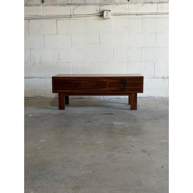 This minimalist low storage unit features a beautifully streamlined rectangular frame with thick square legs. One...
