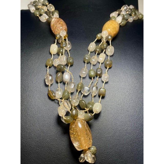 A multi four strand necklace, 21” in length with contrasting gemstones of rutile quarts and labradorite with large barrel...
