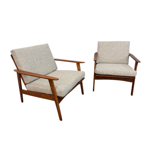 Stunning pair of Mid-Century Modern walnut arm chairs dating back to the 1960s! These beautifully restored lounge chairs...