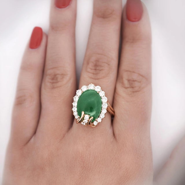 GIA-certified 9 Carat Type "A" green jadeite jade set in 18K yellow gold with a stunning round cut white diamond halo....