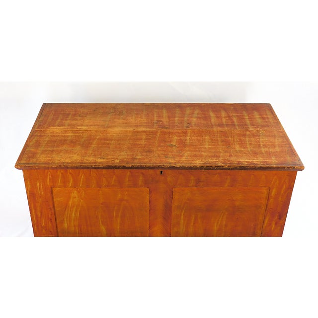 Pennsylvania Flame Orange Painted Blanket Chest, c. 1870 Grain painted chest with recessed rectangular panels and turned...