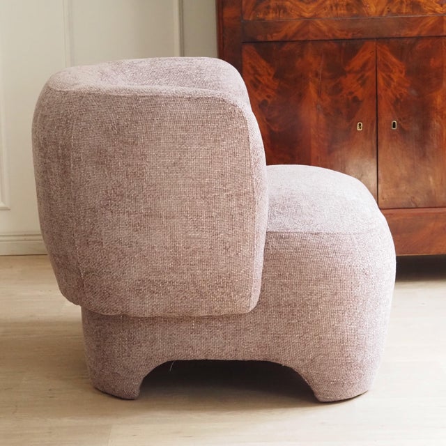 This armchair is a newly produced piece of seating furniture with a completely enclosed, voluminous body and a...