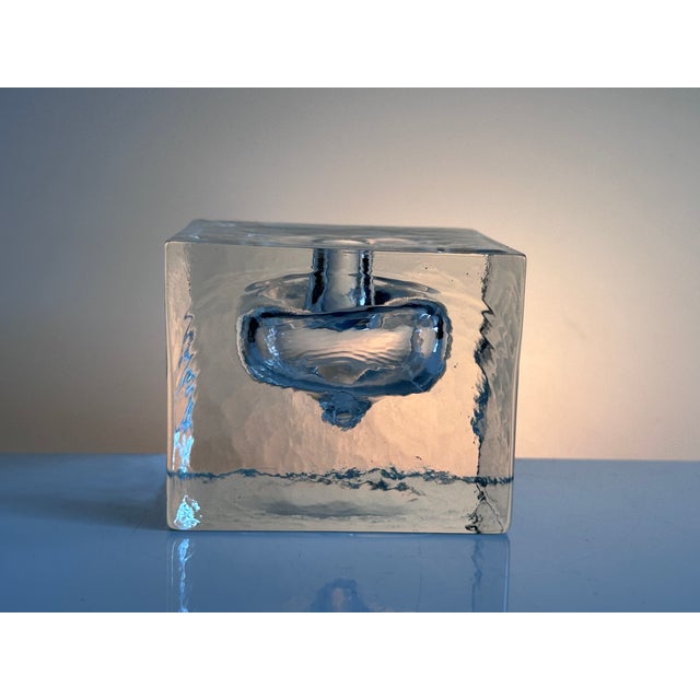 Massive, clear glass block vase made of ice glass in a square shape with an integrated optical body that impressively...