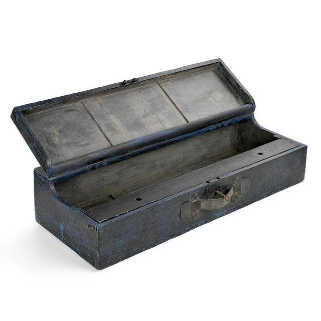 This antique wooden box seduces with its deep blue patina, almost charcoal, marked by the traces of time and past uses....