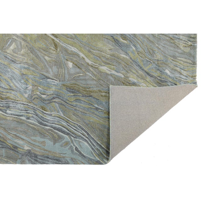 Transform your living space with this modern hand-tufted rug, featuring an organic pattern inspired by natural stone...