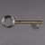 A vintage 20th Century English white metal display key from an English locksmith’s shop, fitted with small brass hooks for...