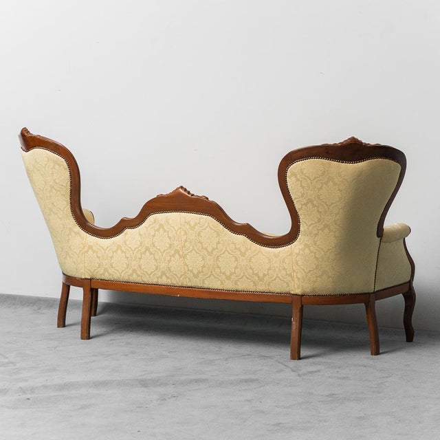 Sofa in Louis Philippe style dating back to the early twentieth century. Upholstery in yellow fabric and wooden structure....