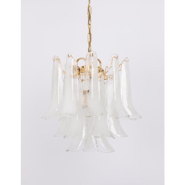 A stunning murano glass petals chandelier in style of mazzega, italy, manufactured in the 1980s. The chandelier is...