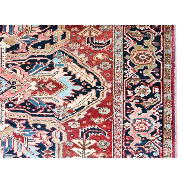 This mid-20th-century Persian Heriz rug features a bold, geometric medallion design characteristic of the Northwest...