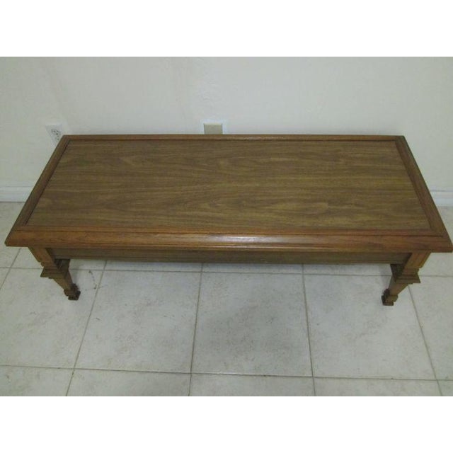 This vintage MCM coffee table is a one-of-a-kind piece that will add character to any space. With a beautiful walnut wood...