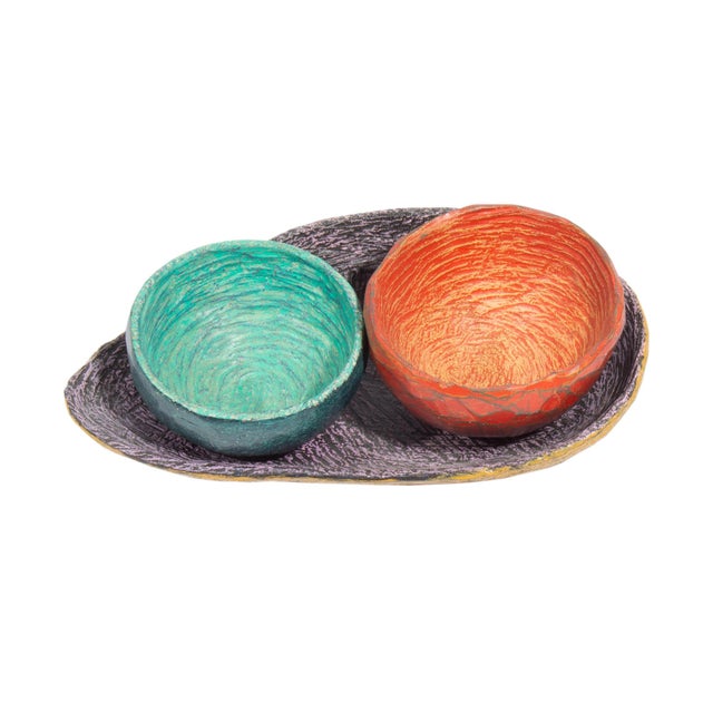 A ceramic sculpture by American artist Valerie Eickmeier. This sculpture includes three pieces: a wide purple tray, a...