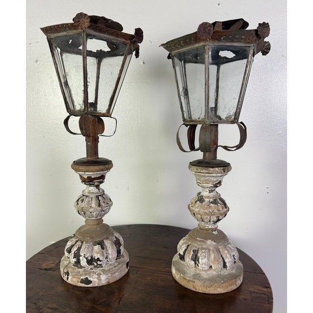 This rare pair of late 19th-century Italian lanterns combines rustic ironwork with elegantly carved wooden bases,...