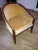French Classic Empire style barrel back tub chair, with brass ball and carved details. Upholstery is worn. Chair is very...