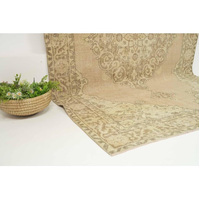 This vintage hand-knotted area rug is a semi-antique vintage area rug. The '70s Eastern Anatolian region's unique rug is...