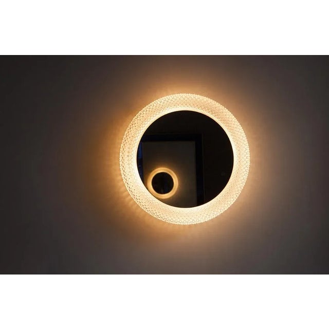 Wall mirror with lamp, Prod. Limburg, Germany circa 1970, mirror glass, transparent glass, metal suspension, inside three...