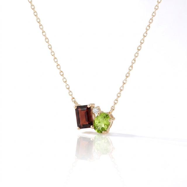 Garnet & Peridot Celestial Bloom Necklace: Nature’s Harmony in Gold Discover the enchanting balance of earth and light...