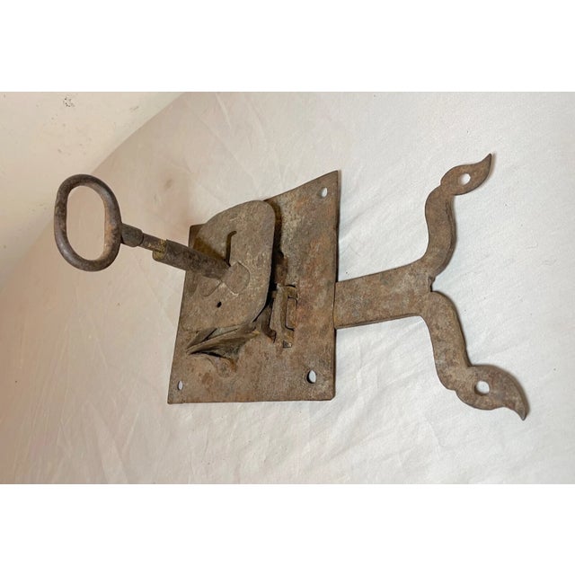 This antique wrought iron skeleton key lock is a true piece of history. Crafted in the 18th century, this handmade lock is...