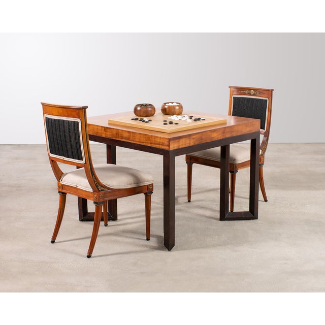 A modernist square "Normandie" games table by Therien Studio Workshops, constructed from oak with a dramatic Koa wood...