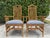 A handsome pair of rattan host chairs featuring elegant pagoda backs, hand-wrapped joinery, and a refined architectural...