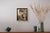 The painting features a figure in profile, exuding a sense of contemplation and nostalgia. The muted earth tones create a...