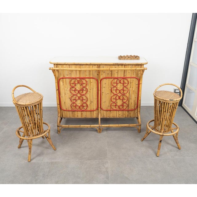 Midcentury amazing cabinet cocktail bar in bamboo and rattan with white formica top and pair of round stools in rattan and...