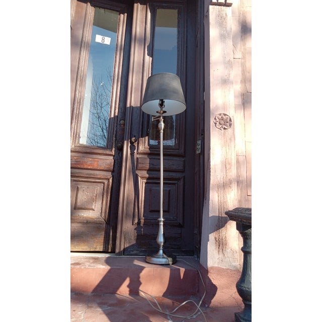 Envision a stunning floor lamp: a slender, sleek body with a subtle sheen casting a sophisticated glow. This lamp stands...