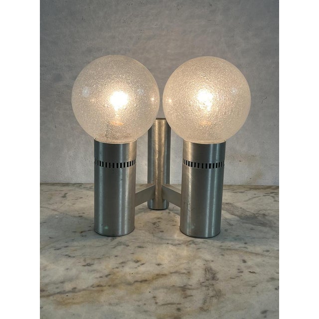 2-light brushed steel and glass wall lamp, Made in Italy, 1970s Intact and in good condition, E27 lamps European Plug (up...