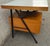 Center desk with a tubular metal frame, two wooden drawers, and a wooden top with Formica on top. An original example of...