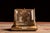 Early 20th-century vanity casket featuring a hinged beveled glass lid, gilt metal framework, and a textured fabric-covered...