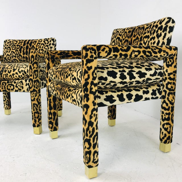 Pair of Parsons chairs in the style of Milo Baughman with custom brass sabots. Available in new velvet leopard upholstery...