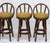 Exceptional set of 4 vintage bent bamboo swivel stools. Each features a mustard vinyl seat cushion with a bent bamboo back...