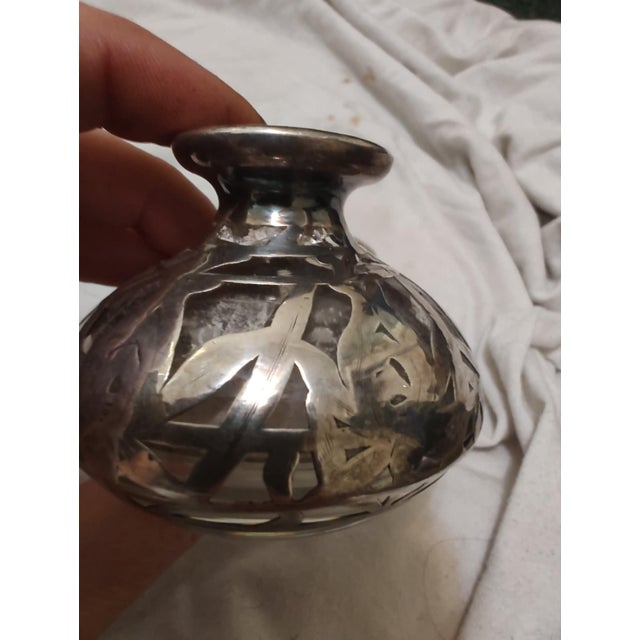 1910 glass and Sterling silver wrapped/inlay perfume bottle. Good condition for its age.