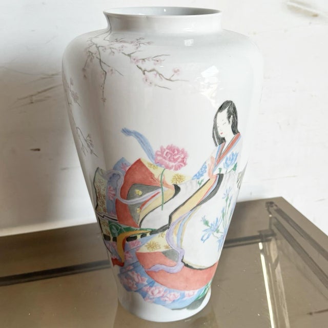 This elegant vintage porcelain vase features a refined chinoiserie scene rendered in soft, painterly tones. Hand-painted...