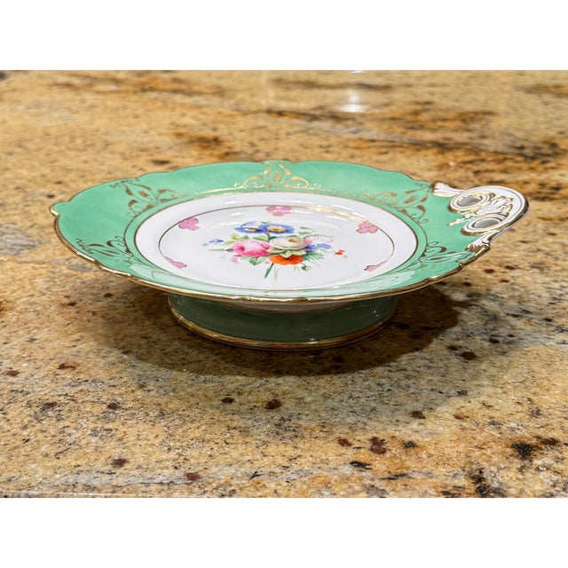 Up for sale is a stunning antique porcelain pedestal serving dish featuring a delicate hand-painted floral centerpiece....