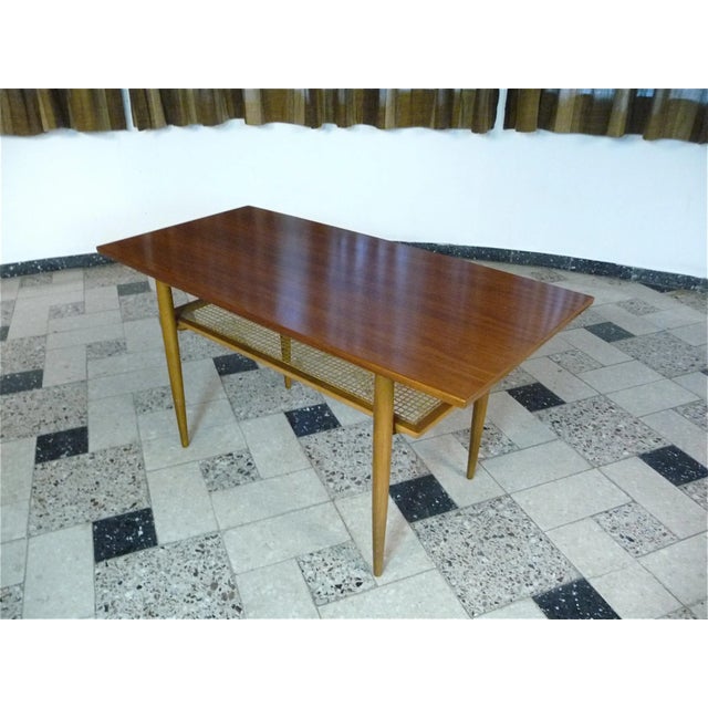 This mid-century modern coffee table was manufactured by Wilhelm Knoll, Germany in the 1960s. It features a shelf...