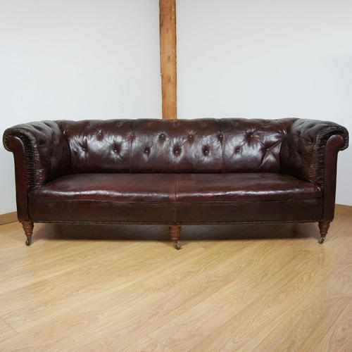 A late victorian buttoned back chesterfield sofa. Original restored leather with re-upholstered sides and back. Original...