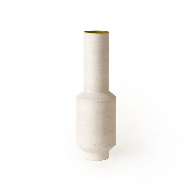 This vase was turned by hand in refractory white earth and is made from two-toned matt enamel in tortora and green. The...