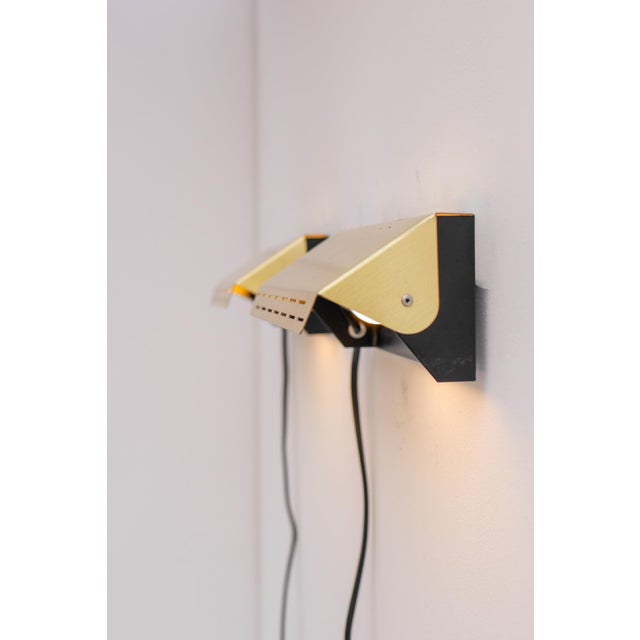 A pair of really beautiful and elegant mid-century modern Scandinavian atomic brass or gold colored wall lamps, also known...