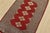 A tribal Bokhara Jaldar rug hand-knotted with fine wool on a cotton foundation. This rug features a row of repeating...