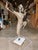 Make a bold statement with this contemporary figurative sculpture, featuring a polished nickel-finished brass figure...