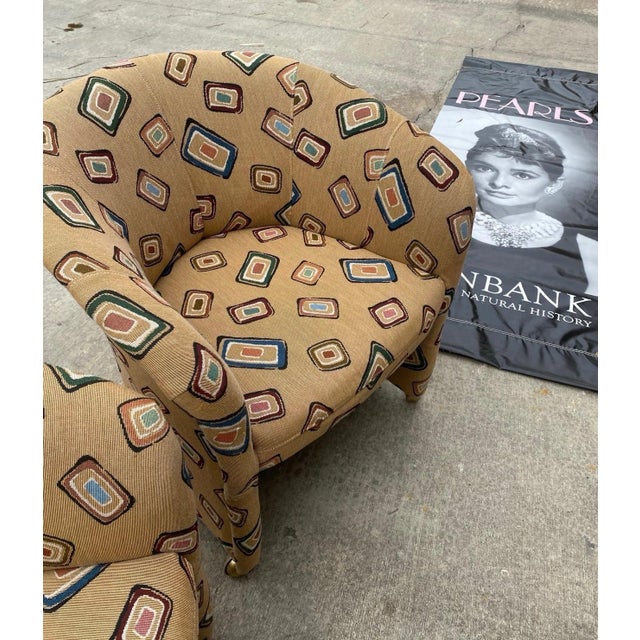 Up for consideration is a beautiful vintage pair of fun design covered tan chairs on wheels, with one front wheel missing....