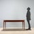 Dining table of Italian manufacture from the 1950s-60s, made of teak wood. The structure features a clean and linear...