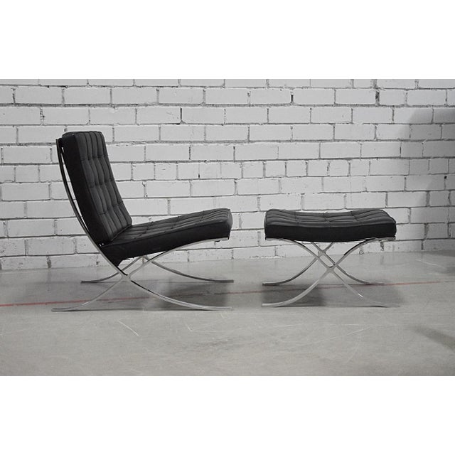 An iconic ‘Barcelona’ Chair in black leather, with foot stool. Designed by Mies Van der Rohe for the 1929 Barcelona...