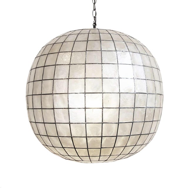 Stunning contemporary globe lantern made from delicate capiz shell square pattern bonded together with pewter finish...