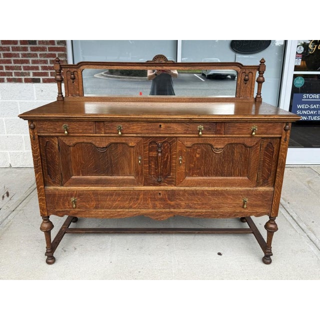 This substantial antique oak sideboard, crafted by J.B. Van Sciver Co. in Camden, NJ, showcases richly figured grain,...