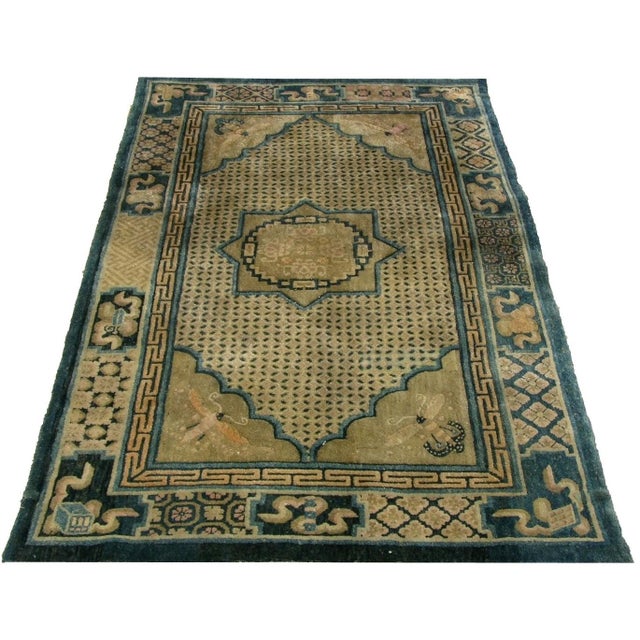 This distinctive early 20th-century Chinese rug features an unusual combination of geometric ornament, stylized floral...