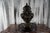 Bring timeless European elegance into your home with this impressive neoclassical urn featuring dramatic lion-head masks...