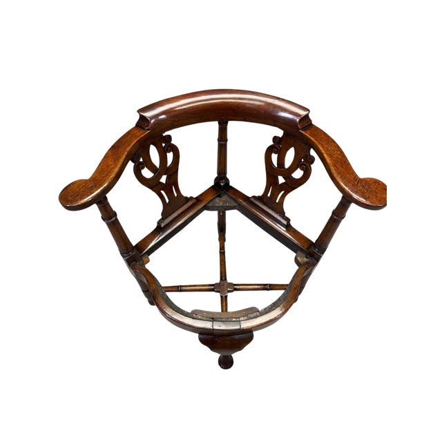 A refined late 19th-century English corner chair crafted in richly toned walnut, executed in the Queen Anne Revival taste....