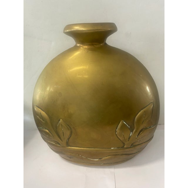 Beautiful large brass vase from Dolbi Cashier has a floral design at the bottom. It has an 80s Hollywood regency style and...